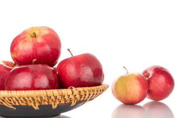 Several ripe red apples with a ceramic dish, macro, isolated on a white background.