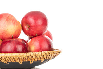 Several ripe red apples with a ceramic dish, macro, isolated on a white background.