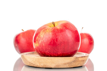 Three ripe red apples with wood saucer, macro, isolated on white background.