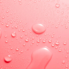 Pink pastel water drops on light shiny surface