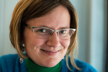 Fototapeta premium Close up portrait of a smiling 30 year old white woman, indoors, Lisbon