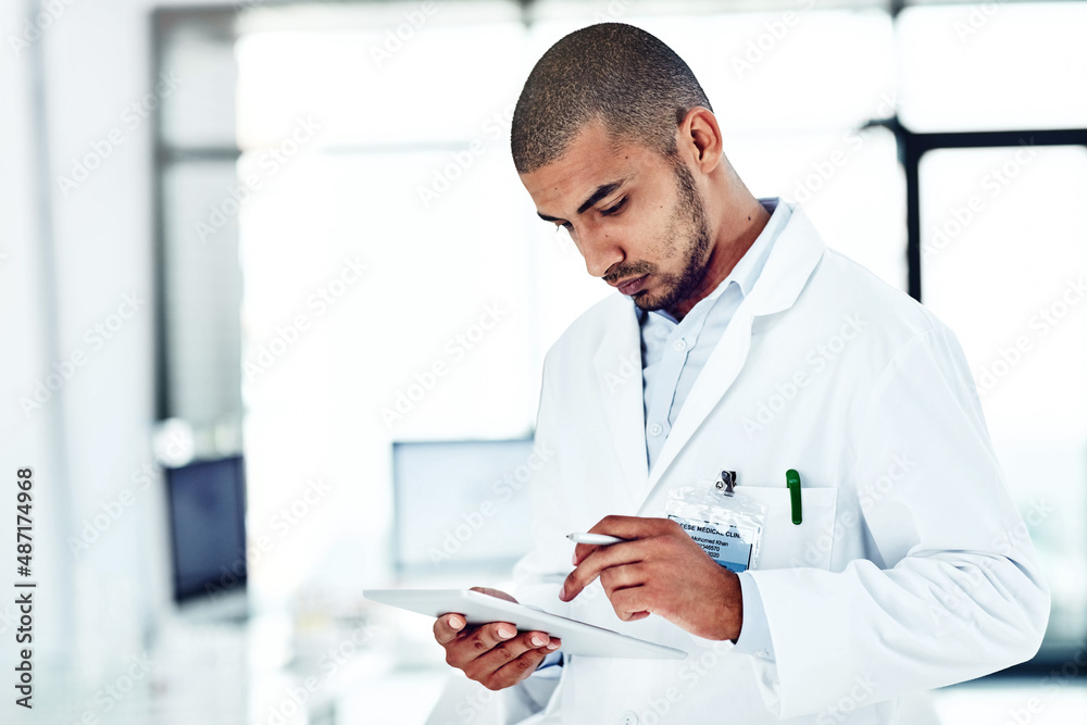 Aufkleber He likes to solve puzzles and problems. Shot of a scientist recording his findings on a digital tablet.