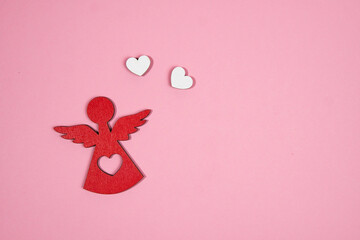 angel with two hearts on a pink background
