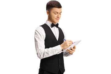 Naklejka na ściany i meble Young male server with a bow tie writing down an order