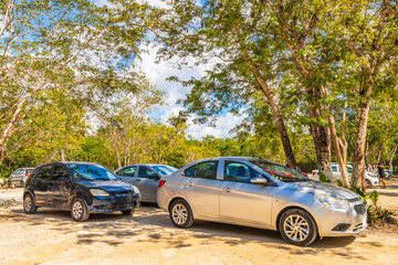 Fototapeta na wymiar Parking lot with cars jungle to Kaan Luum lagoon Mexico.