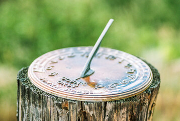 Close Up of a Sundial With a Simple Green Background