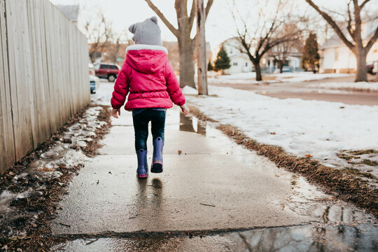 Young girl goes on walk through neighborhood during winter