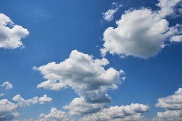 Naklejka na ściany i meble White cumulus clouds in blue sky, beautiful cloudscape background