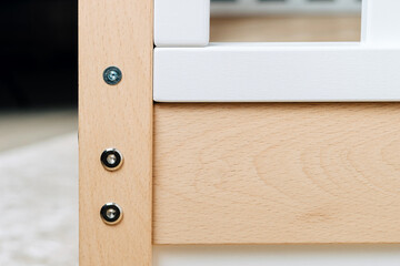 The image of the child's bed, close-up of fasteners details.
