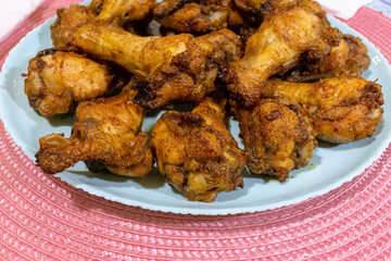 Juicy and crispy fried chicken wings. Full plate of delicious and crispy chicken wings 