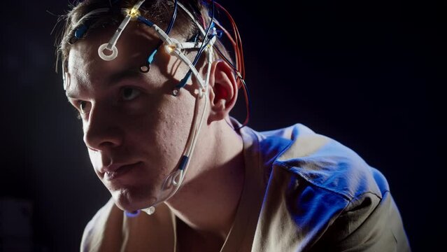 EEG topographer for examining brain, making electrogram of scalp activity. Researching of brain work, sportsman riding bicycle in electroencephalography headset. Rehabilitation after damage in sport.