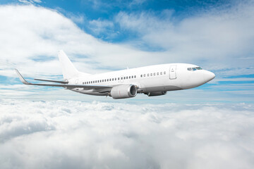 Fototapeta na wymiar White passenger jet plane in the blue sky. Aircraft flying high through over stratus clouds.