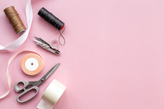 Pink background with sewing accessories and fabric, tailoring supplies  Stock Photo by Jannissimo