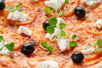 homemade pizza with tomatoes, olives and young cheese.