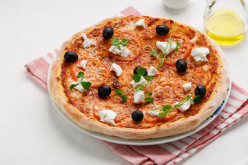 homemade pizza with tomatoes, olives and young cheese.