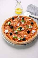 homemade pizza with tomatoes, olives and young cheese.