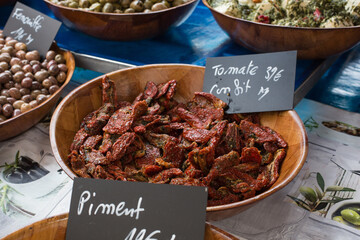 Delicious dried red tomatoes flavored with herbes and oil at a farmers market stall in Provence, Côte d´azur, France