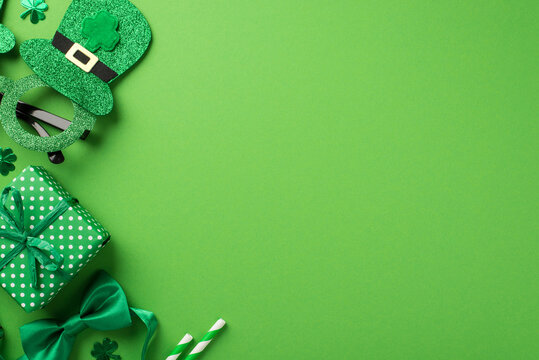 Top view photo of st patricks day decorations hat shaped party glasses green bow-tie shamrocks confetti straws and giftbox on isolated pastel green background with copyspace