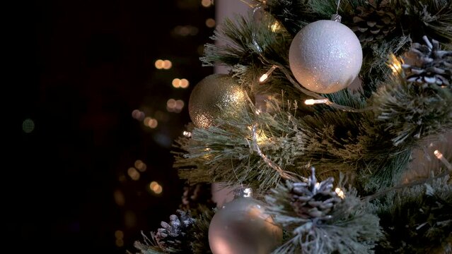 Christmas tree with golden balls and a luminous garland 