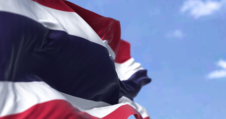 Detail of the national flag of Thailand waving in the wind on a clear day.