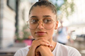 Portrait close up of young beautiful girl, on street