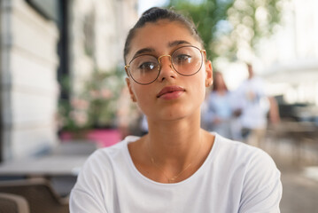 Portrait close up of young beautiful girl, on street