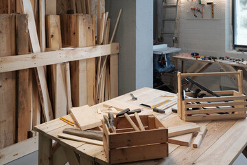 Background image of carpentry workshop with focus on wooden tool boxes in foreground, copy space