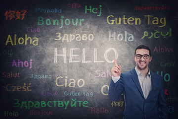 Confident businessman knows different languages. Person shows index finger to the blackboard with...