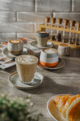 
some coffee and bread in front of the wall in the morning