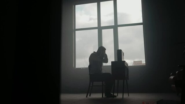 Espionage concept. Special secret agent listens on the reel tape recorder. Officer wiretapping in headphones. KGB spying of conversations.