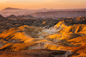 Sunset over the badlands of Moonlandscape in the Namib desert in the vicinity of Swakopmund,...