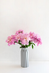 Still life with a beautiful bouquet of pink peony flowers. Vertical crop. Copy space.
