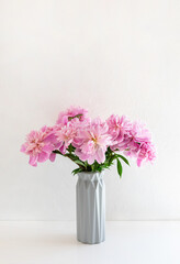 Still life with a beautiful bouquet of pink peony flowers. Vertical crop. Copy space.