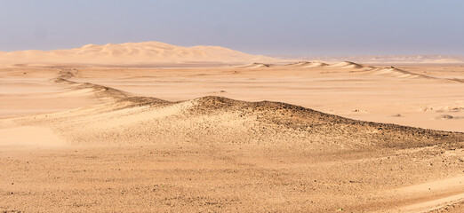 Fototapeta na wymiar Panorama image of a landscape with sand dunes in the Namib desert along the Atlantic coast of Namibia