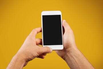 Human hand using smartphone with a blank screen