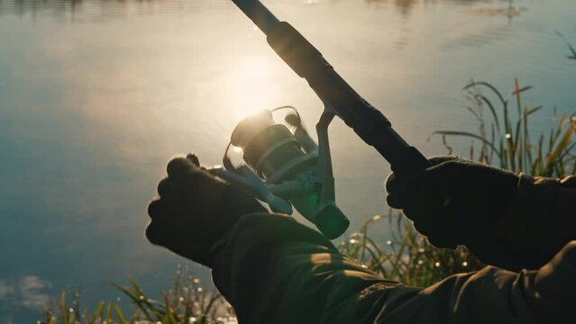 b roll sun rays shines on hands holding fishing rod fisherman enjoy autumn outdoors leisure