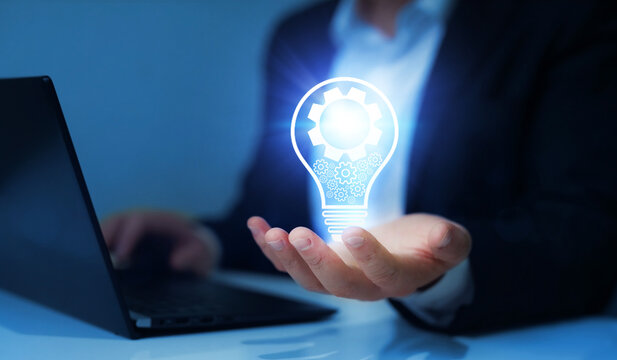 Businessman hand holding glowing light bulb with mechanical gear. Innovative technology and  idea concept. imagination. Creative, inspiration and imagination.