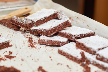 Chocolate brownies on a metal tray freshly made.