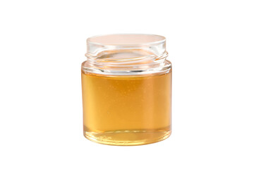 honey from a glass jar stands isolated on a white background