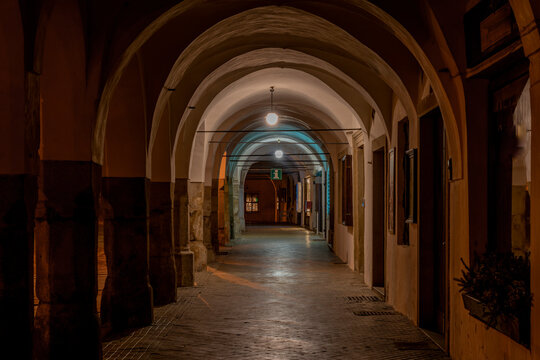 Telc town in winter night with orange street lamps and old loggia