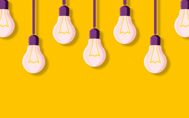 Naklejka premium Transparent light bulbs hang on a yellow background and cast a shadow. Creative business idea concept.