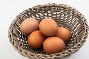 Closeup of fresh brown eggs in Easter basket