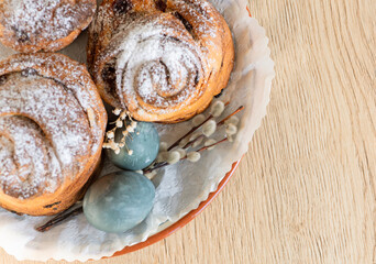 View of Easter cake sprinkled with powdered sugar with marbled eggs