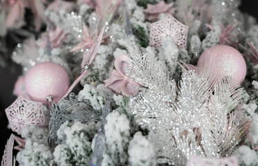Different object toy gifts hanging on a decorated Christmas tree.