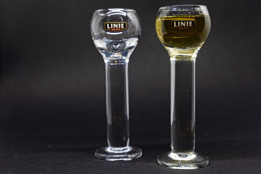 two glasses one filled with Linie aquavit one empty