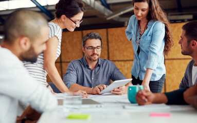 Making tomorrows success today. Shot of a group of coworkers having a meeting in an open plan office.