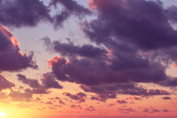 Pink-purple sunset on the background of a cloud of different colors.