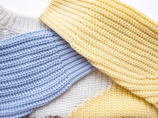 Knitted sweater close-up. Multi-coloured sleeves and neck of a knitted sweater.