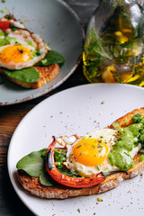 delicious and appetizing bruschetta with fried eggs and herbs for breakfast