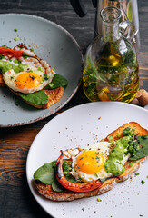 hearty and high-calorie breakfast. delicious and mouth-watering bruschetta with fried eggs and herbs for breakfast with a cup of aromatic coffee.